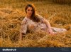 pregnant-woman-in-a-wheat-field-posing-sitting-on-freshly-mown-straw-312292172.jpg