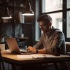 man-is-sitting-table-with-laptop-lamp-hanging-from-ceiling_171308-435.jpg