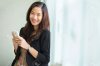 38305012-young-businesswoman-smile-standing-while-carrying-her-cellphone.jpg