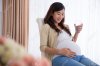 45151259-Pregnant-asian-woman-drinking-glass-of-water-while-sitting-on-a-chair.jpg