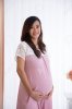 45094153-happy-pregnant-asian-woman-in-pink-dress-touching-her-big-belly.jpg