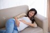 45151167-A-portrait-of-a-Pregnant-asian-woman-laying-on-the-couch-Stock-Photo.jpg