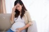 45095680-Pregnant-asian-woman-got-headache-sitting-on-a-couch.jpg